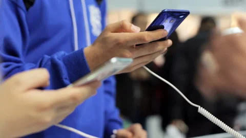 Buying a smartphone in the store Stock Footage 94604295