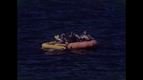 Buzz Aldrin, Neil Armstrong, Fred Haise in life-raft after water egress training Stock Footage 271517878