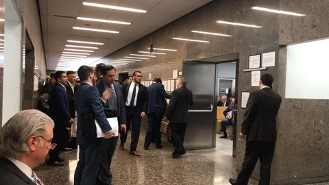 Buzzing lawyers in courthouse Stock Footage 108883328