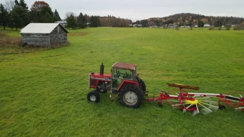 Buzzing the small red tractor Stock Footage 142317114