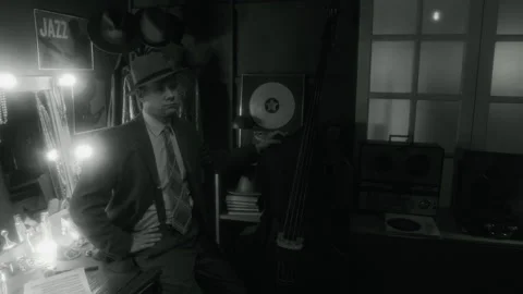 BW Man Posing With Upright Bass and Wearing Hat in Jazz Club Stock Footage 312240382