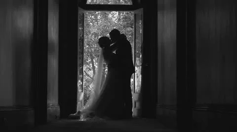 B&W silhouette Bride & Groom kissing, slow motion Stock Footage