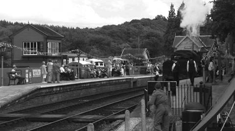B&amp;W Steam train pulls in to traditional 1940s station Stock-Footage 39911163