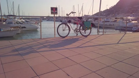Bycicle on the l'Estartit port during sunset summer Stock Footage 138081111