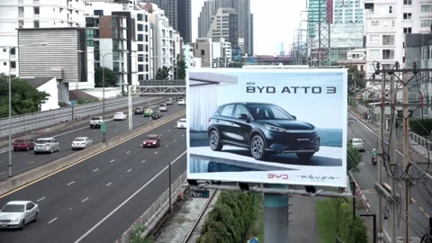 A BYD car advertisement displayed on a screen along the motorway in Bangkok. Video stock 302224116