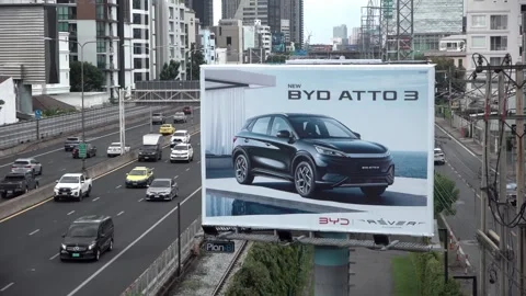 A BYD car advertisement displayed on a screen along the motorway in Bangkok. 스톡 동영상 302224372