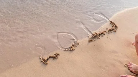 Bye, Year 2019 written on sand beach. ocean wave and lettering on the beach.  Stock Photos
