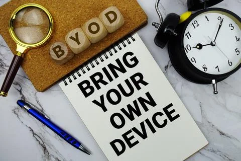 BYOD Bring Your Own Device text written on notepad with calculator and magn.. Foto stock