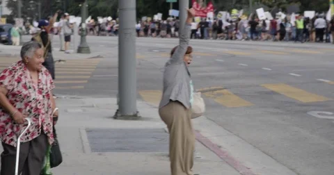 Bystanders cheering DACA supporters march from Echo Park Lake to Olvera in Stock Footage 81574726