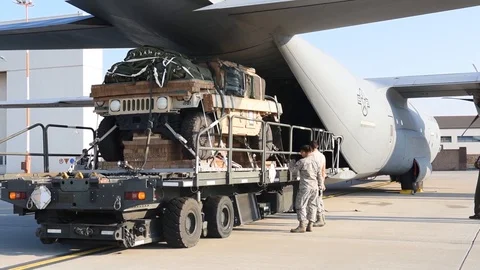 C-130 J loadmaster from Dyess AFB preparing to load a Humvee - 2015 Stock Footage 107537949