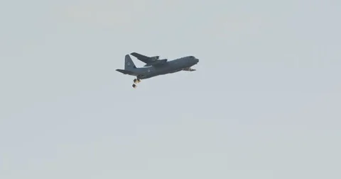 C-130 transport plane dropping cargo packs Stock Footage 100472092