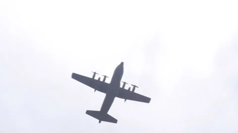 C-130 war airforce plane crosses sun rays Stock Footage 39671286
