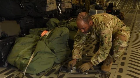 C-17 Globemaster loadmaster securing attachment to cargo compartment floor Stock Footage 109160299