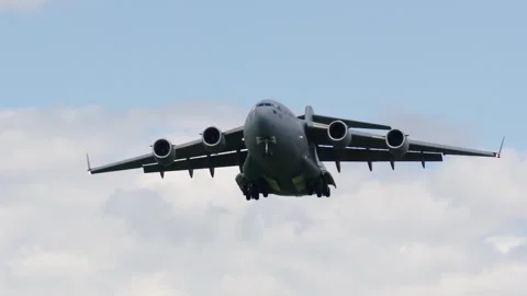 C-17 globemaster performs strategic airlift operation during daylight 動画素材 335980869