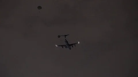 C-5 Galaxy dropping cargo attached to parachutes at night Stock-Footage 105231102