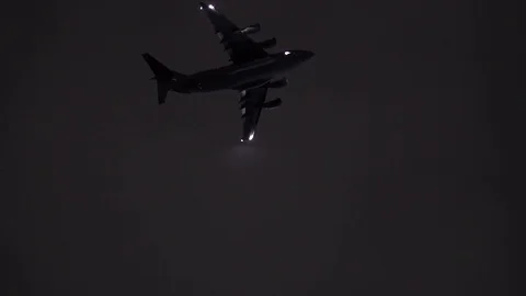 C-5M Super Galaxy flying with lights on in the sky at night Stock Footage 113343764