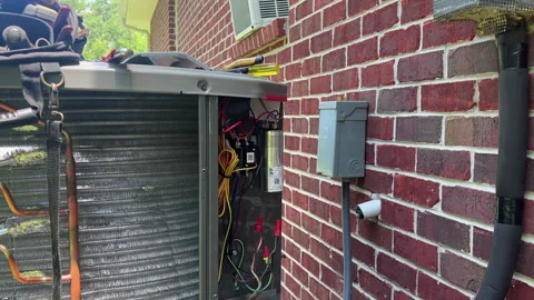 A:c condenser being installed. Freon being added to the A/C unit. Stock Footage 202606215