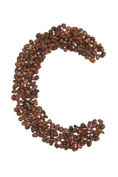 C letter made of cedar  nuts Foto stock