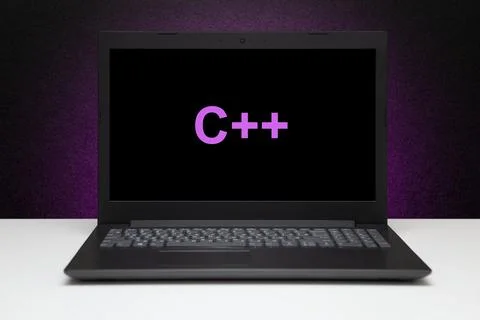 C plus text on laptop screen on textured black background with purple light. 스톡 사진