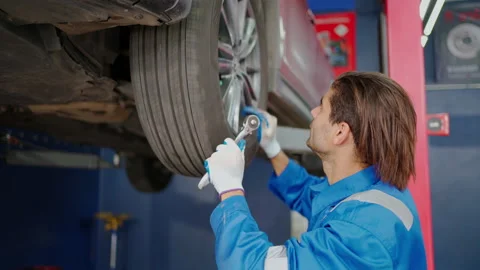 C0030 Mechanic worker checking wheel system Stock Footage 205289319