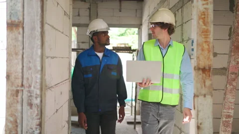 C0059 Engineer and architectural holding laptop and walking on site Stock-Footage 204924916