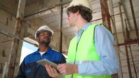 C0061 Engineer and architectural holding tablet and discuss on site Stock Footage 204924990
