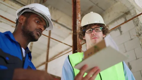 C0063 Engineer and architectural holding house model and discuss on site Stock Footage 204924663