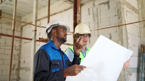 C0064 Engineer and architectural holding blueprints or house plan and discus Video stock 204924536