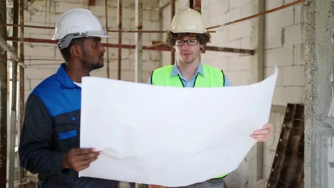 C0065 Engineer and architectural holding blueprints or house plan and discus Stock Footage 204924561