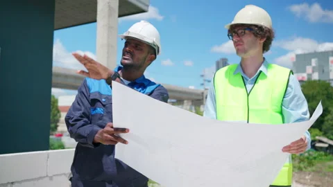 C0066 Engineer and architectural holding blueprints or house plan and discus Stock Footage 204719786