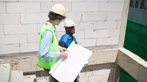 C0068 Engineer and architectural walking downstair at site Stock Footage 204924575