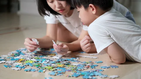 C0100 Son doing jigsaw puzzle withe mother Stock Footage 155094350