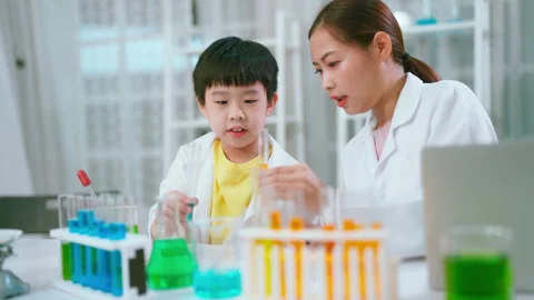 C0126 Asia kid doing experiment with teacher in the laboratory Stock Footage 206090994
