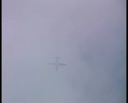 C130 flying through cloud, parachutists jump from rear door. Stock Footage 1044092