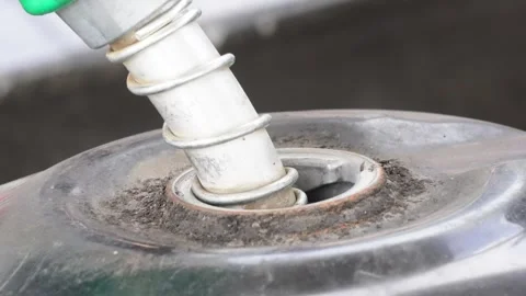 C2047A fuel nozzle inserted into the fuel tank for refueling Stock Footage 314513081
