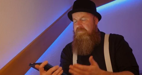 C4K Bearded man is annoyed while surfing the internet using tablet 스톡 동영상 108117078