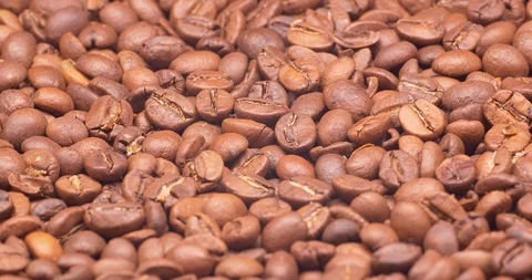 C4K closeup shot of the light or medium roasted coffee beans on a turntable Video stock 99042219