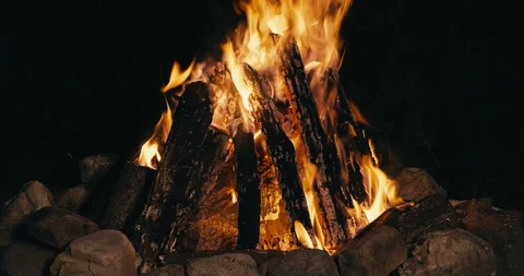 C4K graded shot of a large campfire burning at night time Video stock 96315685