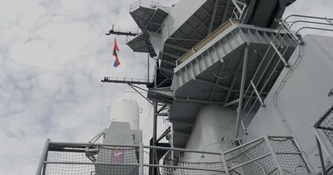 C4K-Looking up flags fly from USS Iowa super structure Stock-Footage 106808833