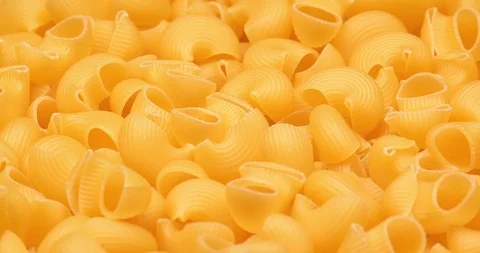 C4K macro of the dry Pipe Rigate pasta on a rotating stand Видео 99042316