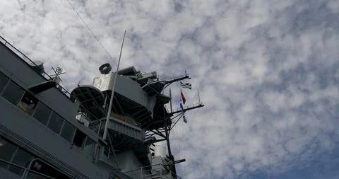 C4K-Warship flags fly against cotton candy sky Video stock 106803634