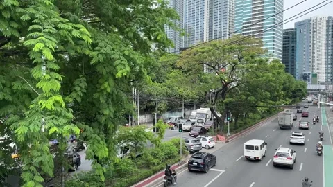 C5 road traffic with commercial vans and trucks Quezon City Manila Vídeos de archivo 337980153