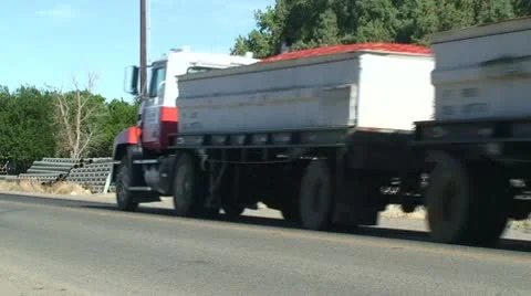 CA Central Valley Water Pipes with Tomato Truck passing Stock Footage