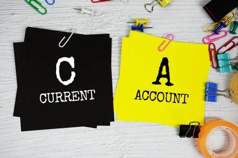 CA - Current Account text on stick note with stationery on concrete backgroun Stock Photos