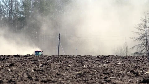 The cab of an agricultural tractor can be seen in the field, the tractor plows Vídeos de archivo 130748806