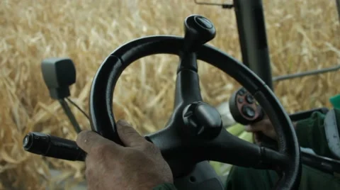 In the cab of combine harvester gathering corn Stock Footage 65729816