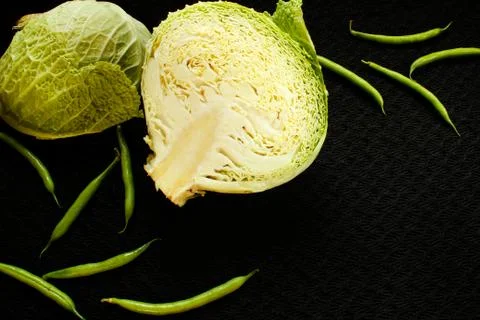 Cabbage and asparagus on a black surface Stock-Fotos
