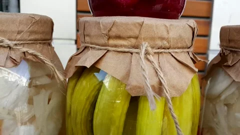 Cabbage beetroot and pickled cucumber in glass jar with graft paper and drawstri Stock Footage 144595181
