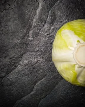Cabbage on a black stone background. Stock Photos