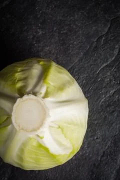 Cabbage on a black stone background. Stock Photos